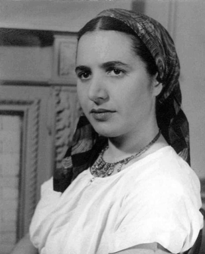 Slobodkina wearing a polychrome silk scarf of her own design. Photograph by Friz Glarner, 1941.