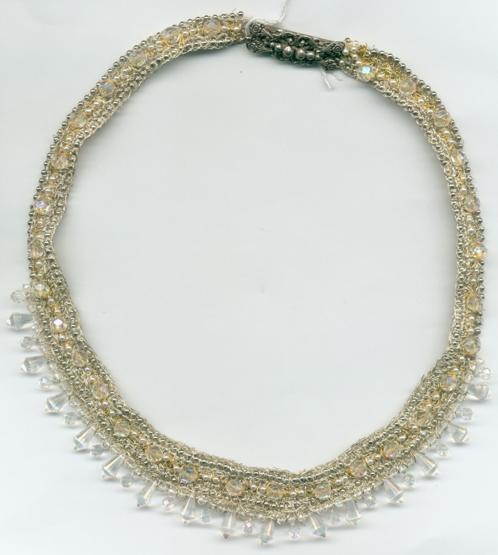 Necklace, crocheted out of silver thread