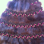Fur hat trimmed with crocheted ribbon and recycled beads