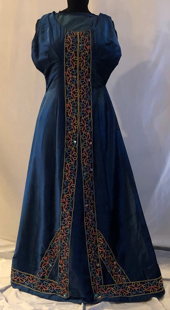 Dress, Blue rayon velvet, trimmed with decorative tape, enhanced with faux jewels.