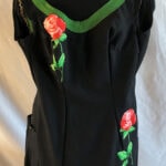 black repurposed bathing suit trimmed with green tape and appliquéd roses