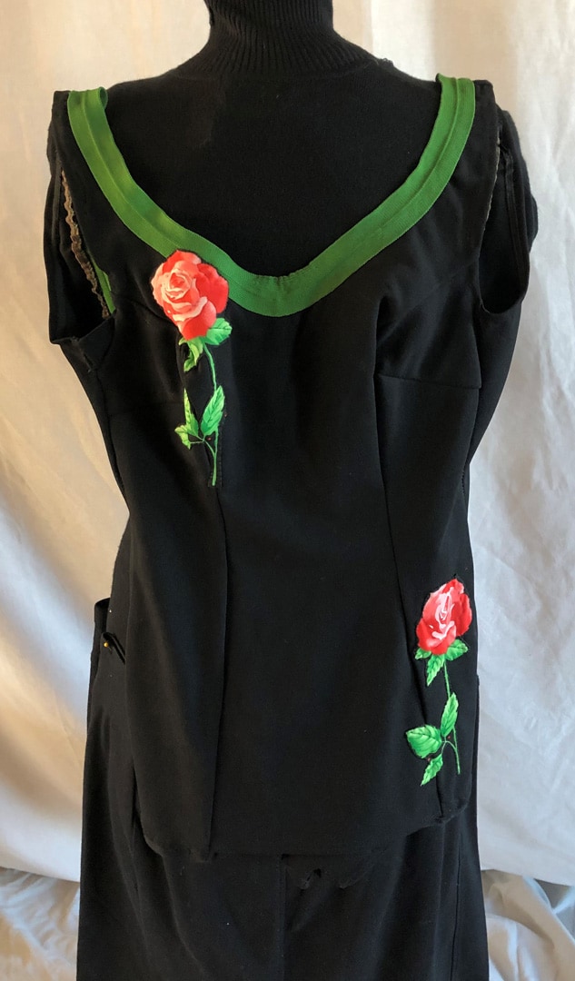 black repurposed bathing suit trimmed with green tape and appliquéd roses